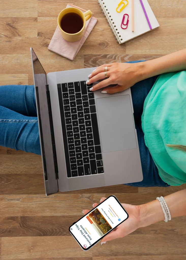 Traveler booking a day trip from Alicante on laptop and smartphone