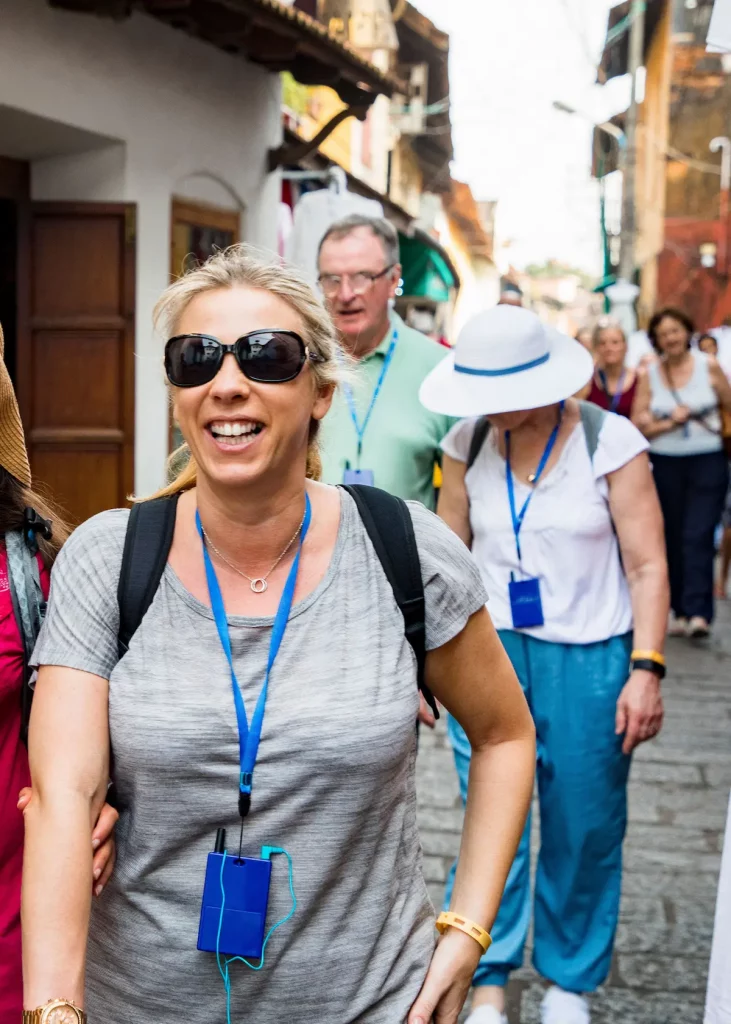 Smiling tourists enjoying a guided walking tour through the charming streets of Alicante old town