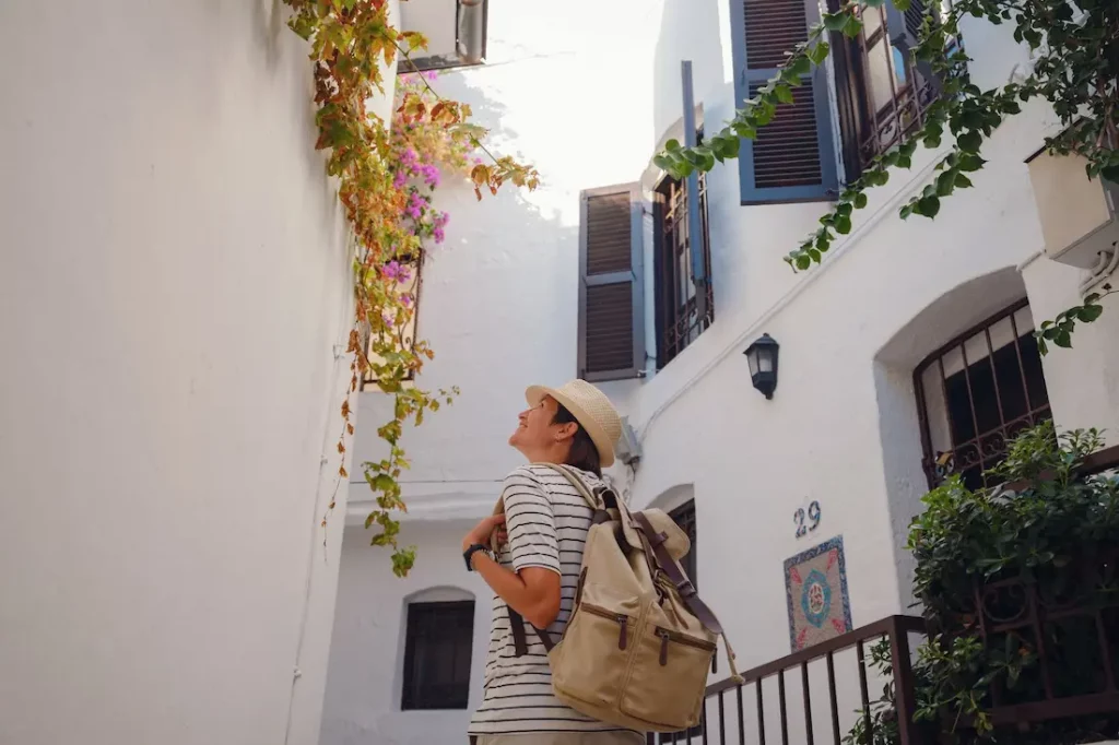 Woman exploring a charming white-washed village, typical of Altea or Costa Blanca.