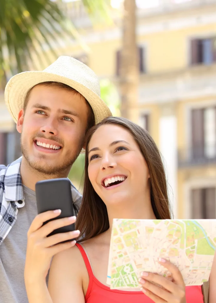 Happy tourists exploring Alicante Old Town with map and phone – Alicante in a Day travel guide