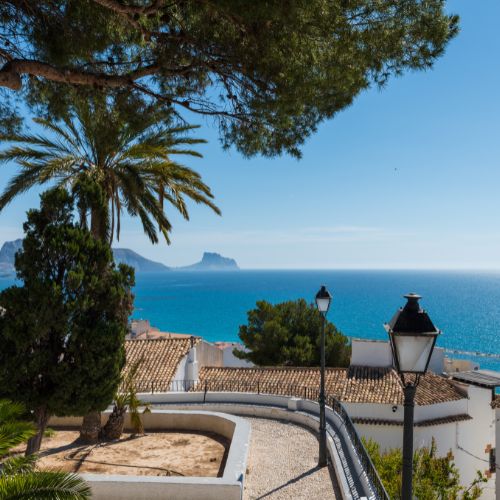 Scenic view from Altea seaside promenade with palm trees, white houses, and the Mediterranean Sea