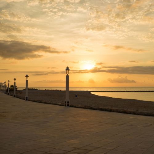 Sunset at Altea seaside promenade with lanterns and calm Mediterranean waters on the Costa Blanca