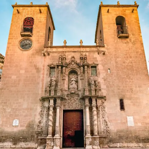 Interior of the Basilica of Santa María in Alicante with Virgin statue and golden dome