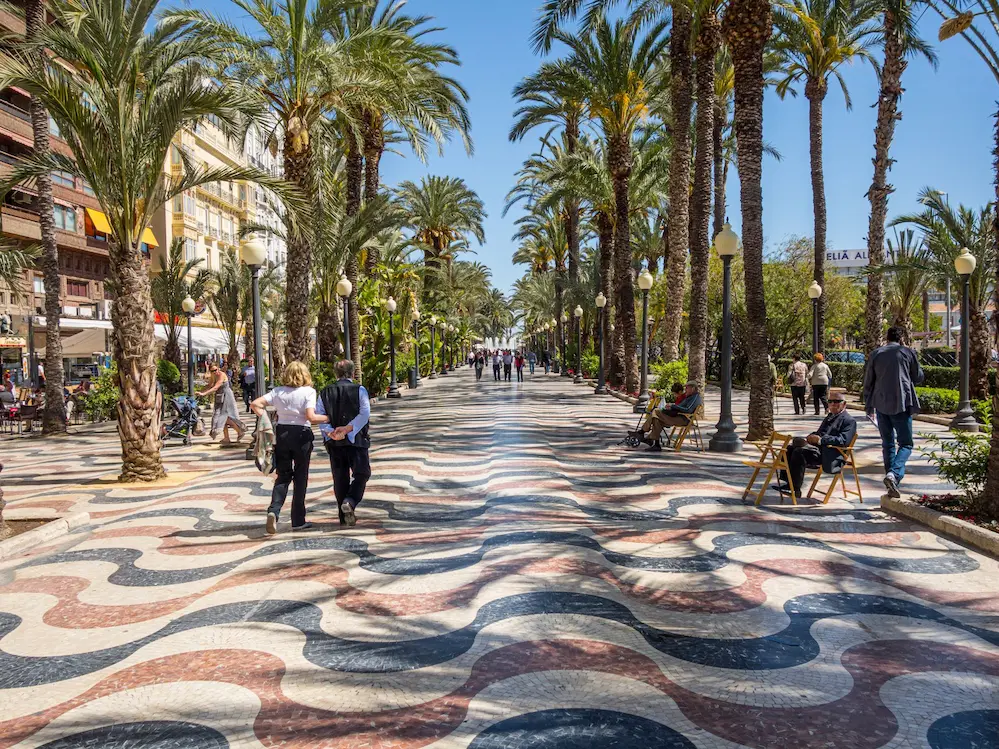 Explanada de España promenade in Alicante with palm trees and colorful marble mosaic floor