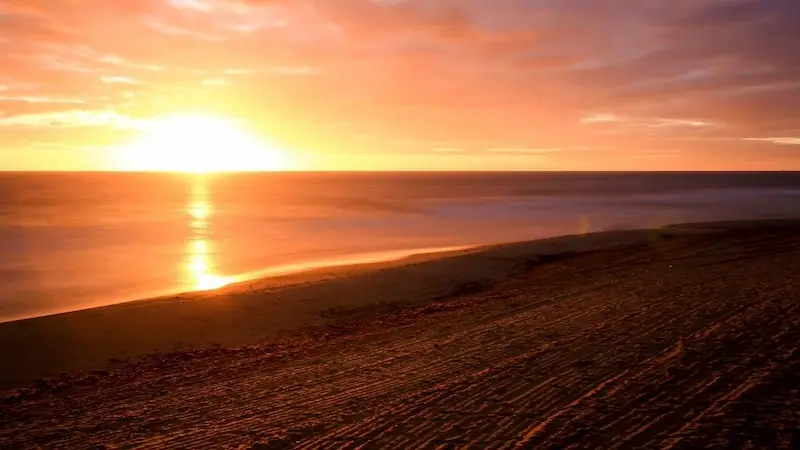 Sunset view at Playa de los Arenales del Sol in Alicante with golden sand and Mediterranean sea