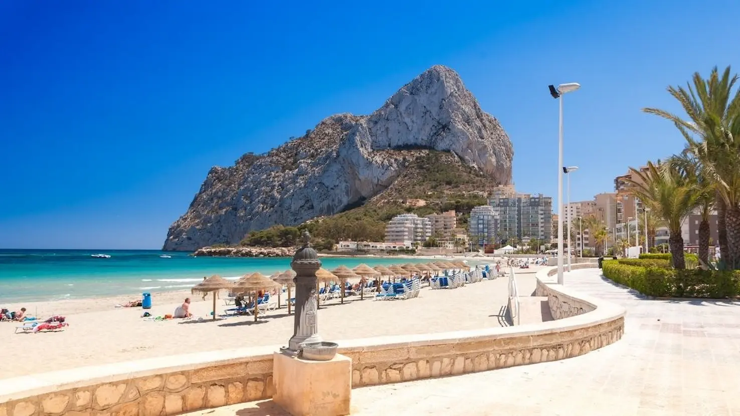 View of Calpe’s Peñón de Ifach and La Fossa Beach on a sunny day, Costa Blanca, Alicante