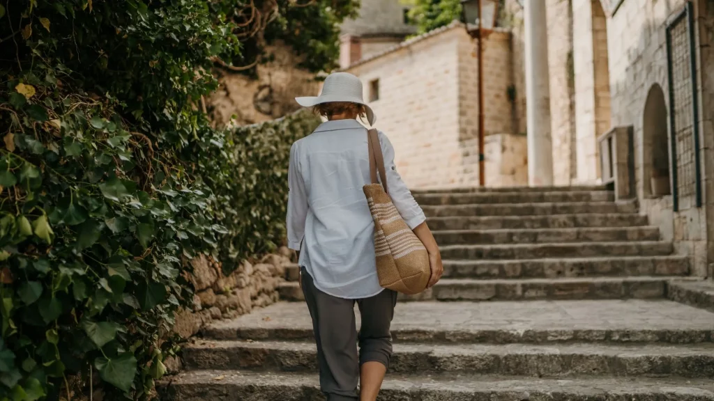Traveler walking up stone steps in a charming village near Alicante, Spain