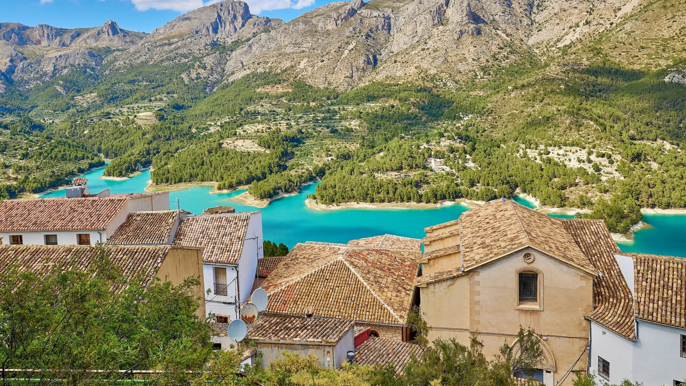 Guadalest village view with turquoise reservoir