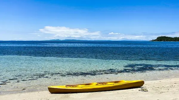 Yellow kayak resting on a calm Mediterranean beach along the Altea coast